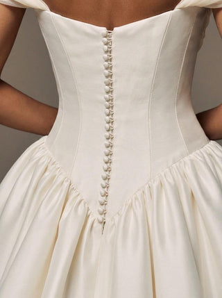 Wilderness silk faille wedding dress with an organza overskirt and a cathedral train