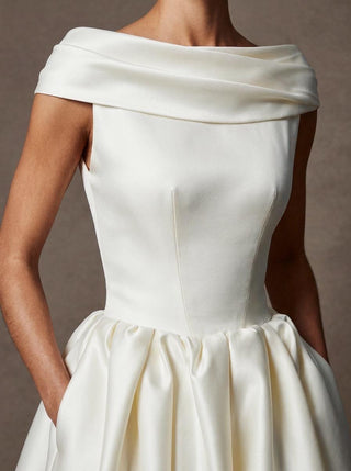 Made-to-measure Margaux ballgown in duchess satin with a folded off-shoulder collar and in-seam pockets