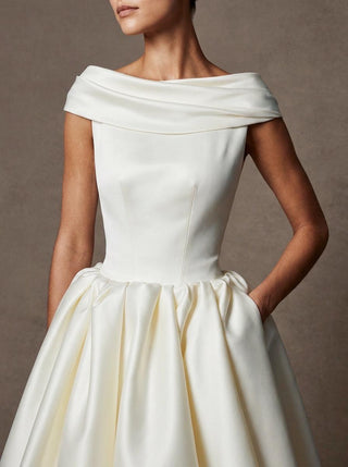 The Margaux duchess satin off shoulder ballgown with folded collar and covered button back, made-to-measure by Sylk Atelier