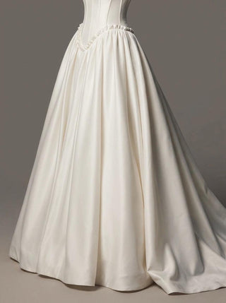 Delphine duchess satin wedding dress with a lace-up corset back and a cathedral train