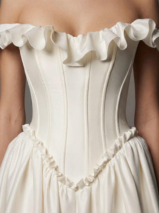 Delphine duchess satin ballgown wedding dress with an off-shoulder ruffle and a lace-up corset back