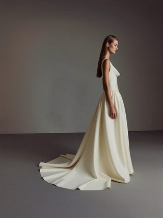 Amoret duchess satin wedding dress with an eyelet lace-up back and a pleated skirt