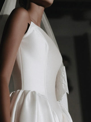 Poise mikado wedding dress with a straight strapless neckline and full gathered skirt to a cathedral train