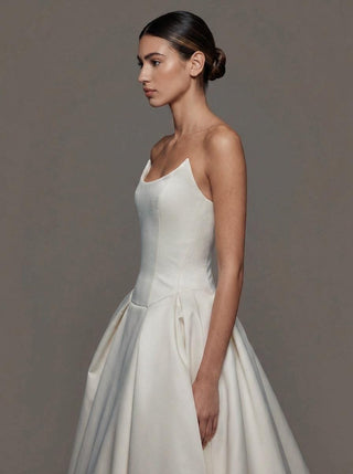 Made-to-measure Vivienne ballgown in duchess satin with a strapless scoop neckline and covered buttons