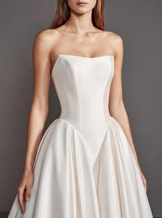 Linnet duchess satin wedding dress with a visible corset and a dropped basque waist