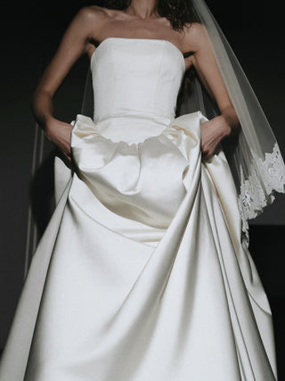 Hever duchess satin wedding dress with a full corset lace-up back in metal eyelets and a cathedral train