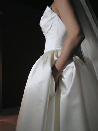 Sandringham duchess satin wedding dress with a full pannier skirt and covered button back to the hip