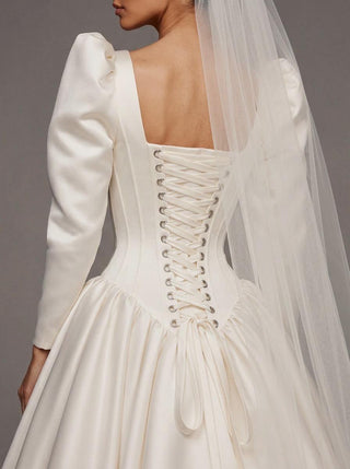 Medici duchess satin wedding dress with a square neck and an architectural corset