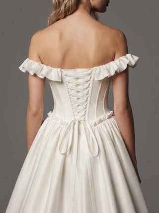 Delphine duchess satin wedding dress with a lace-up corset back and a cathedral train