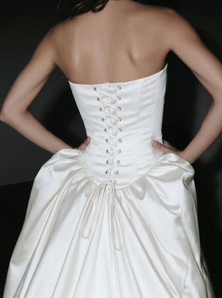Made-to-measure Hever ball gown in duchess satin with a strapless corset bodice and deep side pockets