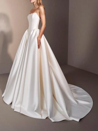 Linnet duchess satin wedding dress with a visible corset and a dropped basque waist