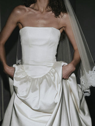 Hever duchess satin wedding dress with a full corset lace-up back in metal eyelets and a cathedral train