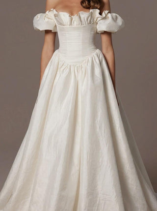 Rowena silk dupion wedding dress with a ruffled neckline and a corset bodice
