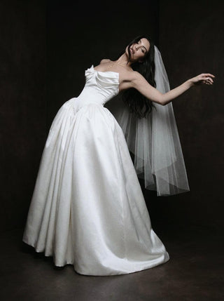 Sandringham duchess satin wedding dress with a full pannier skirt and covered button back to the hip