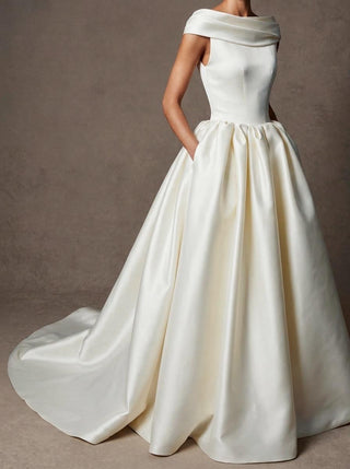 Margaux duchess satin wedding dress with covered buttons and in-seam pockets