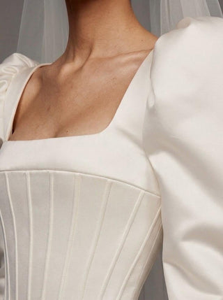 Medici duchess satin wedding dress with a square neck and an architectural corset